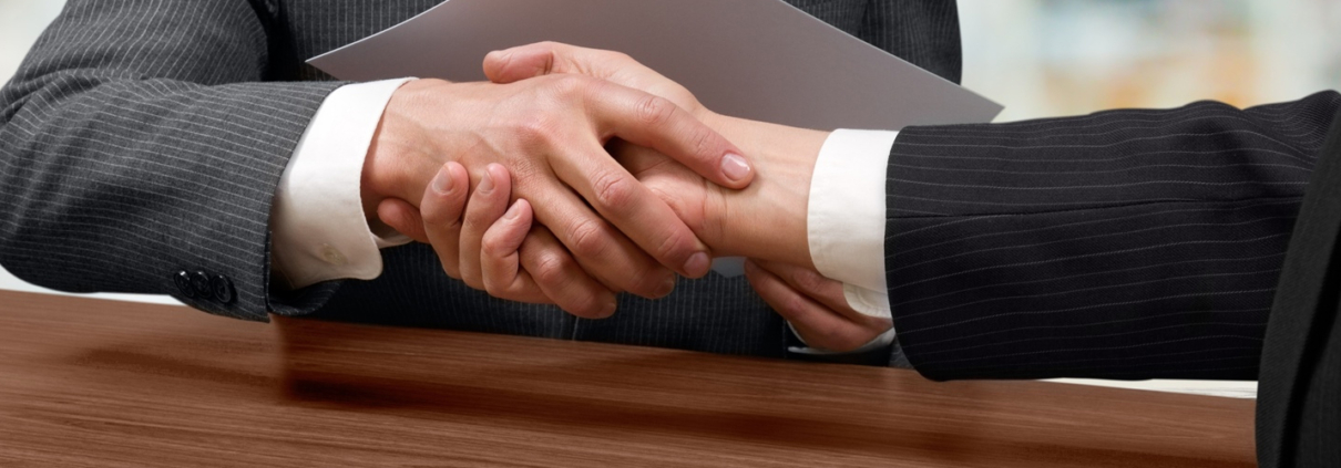 Two business owners shaking hands on a deal